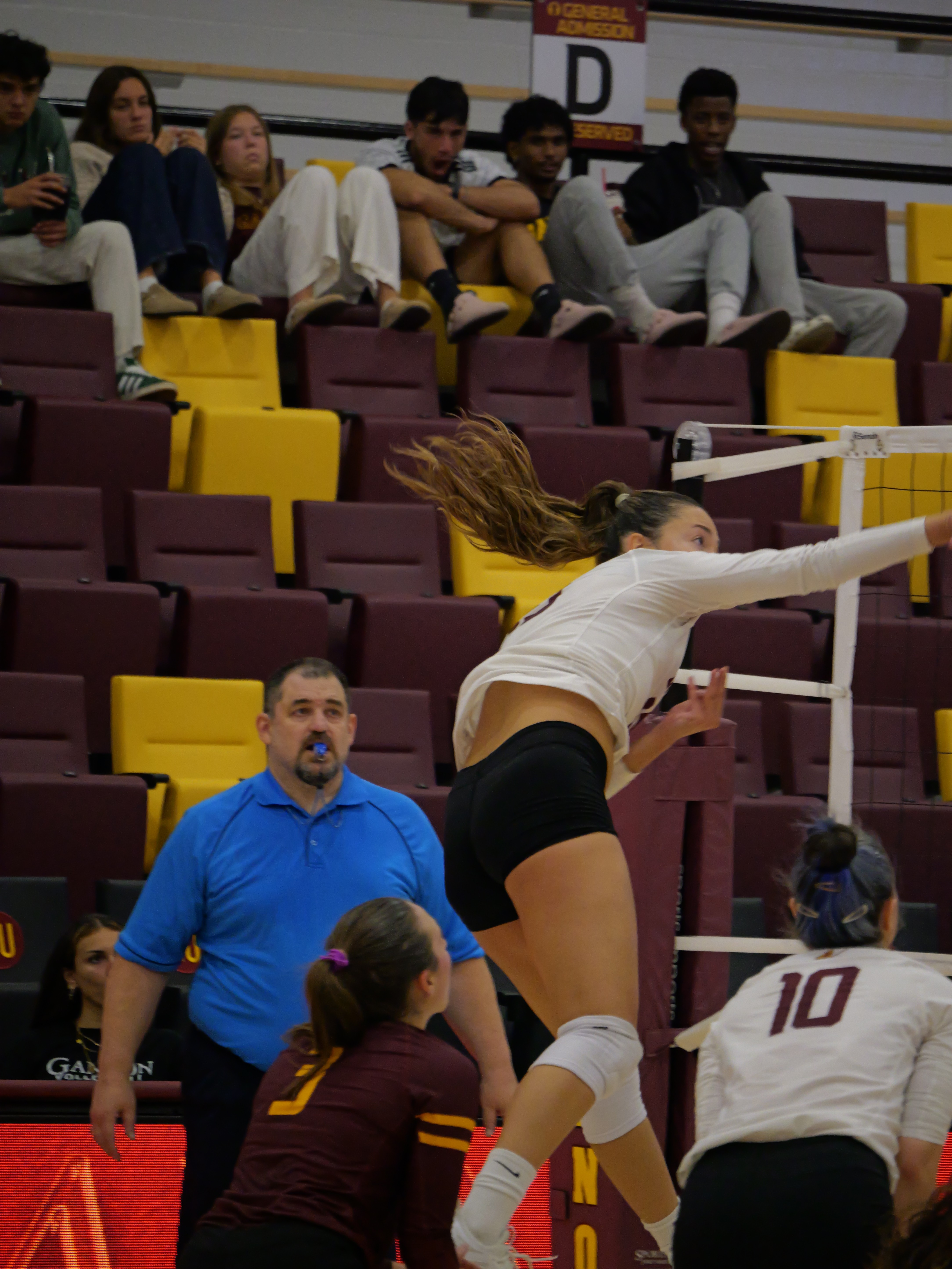 Player attacking the ball at the net — wrist snap at contact