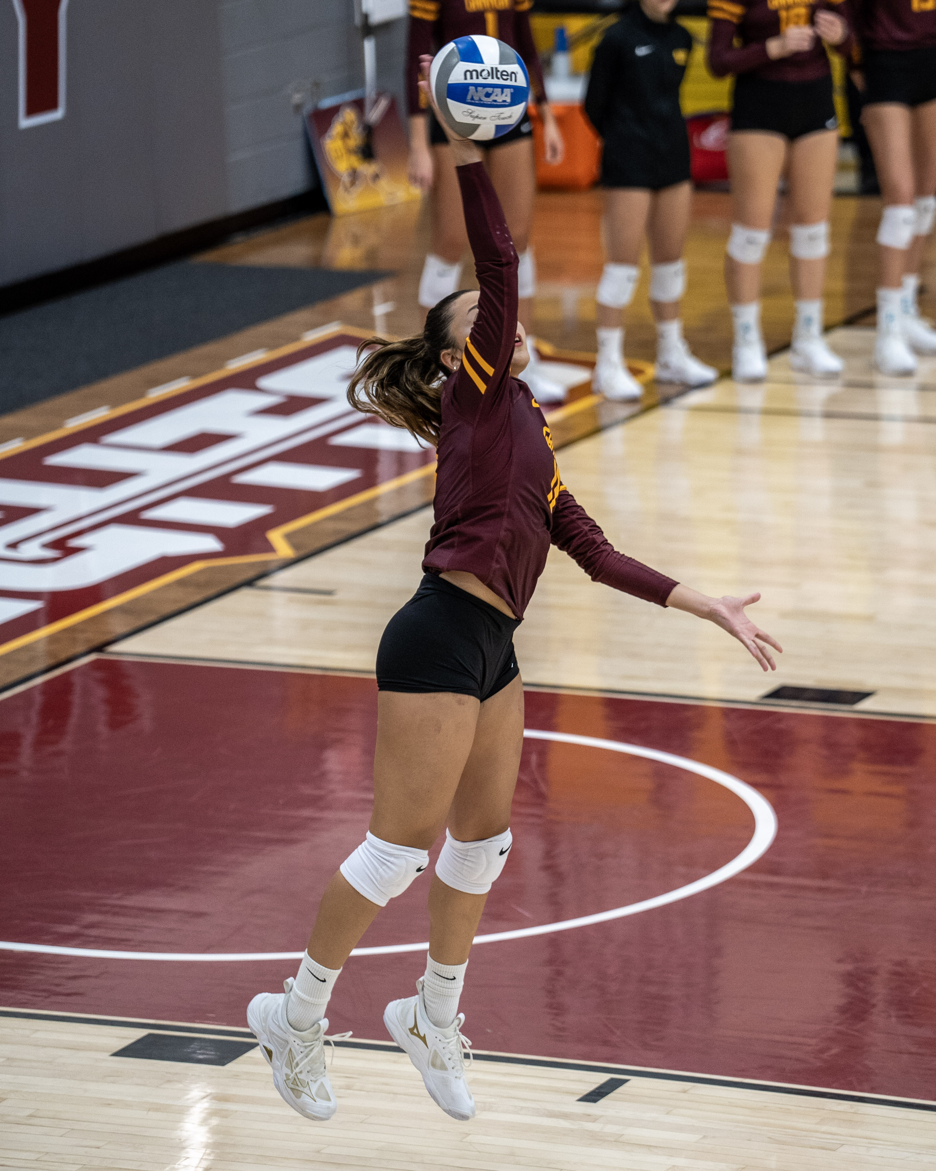 Player jumping to contact the ball with a float serve